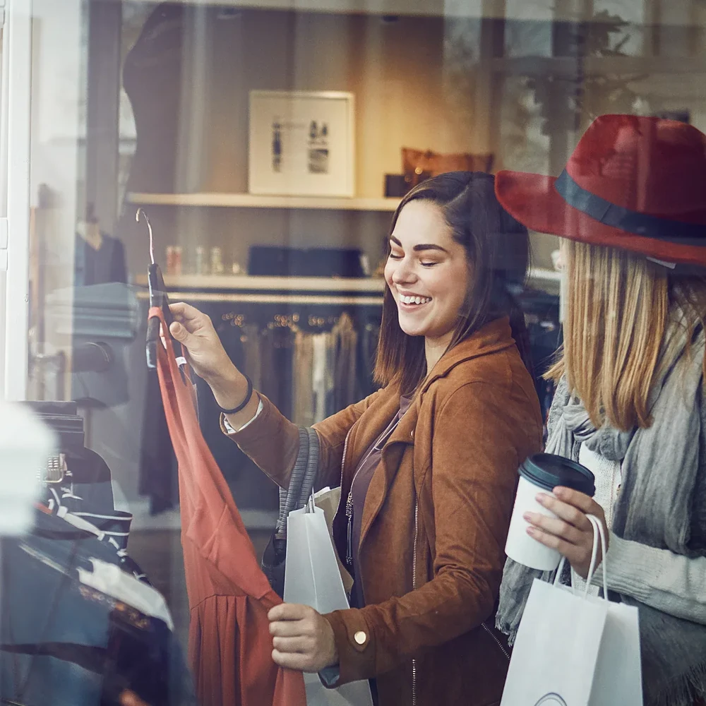 Customers browsing clothing in a shop
