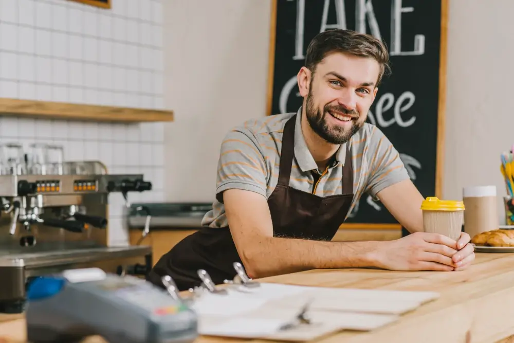 Smiling Bartender with hot beverage