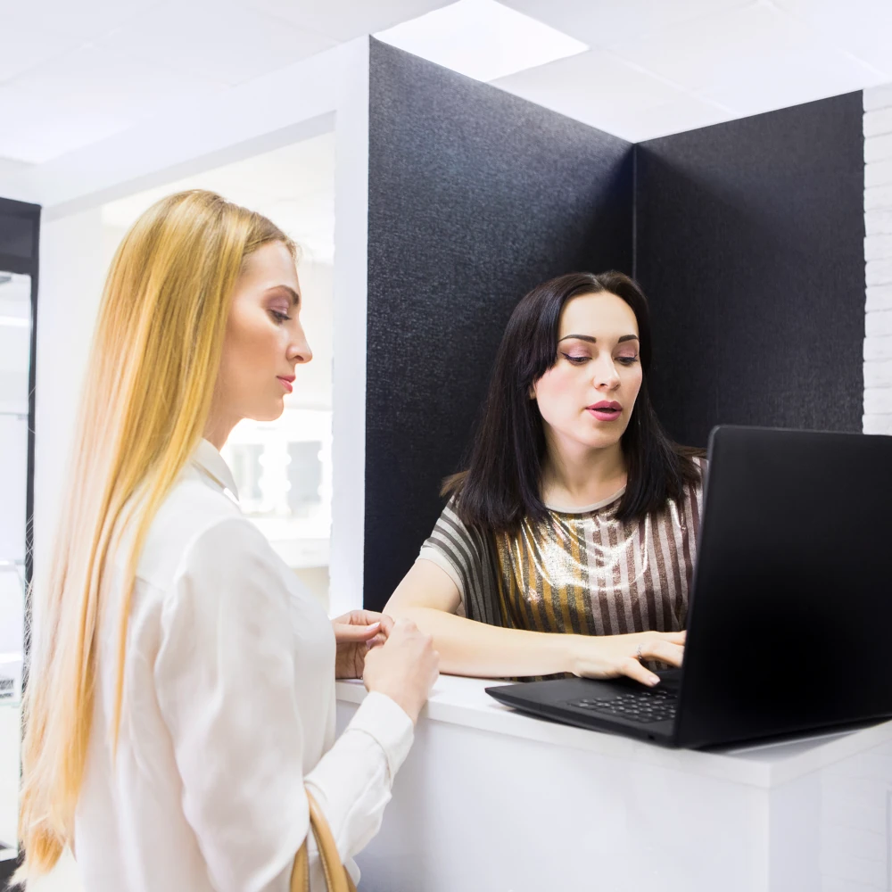A hair and beauty specialist arranging a booking with a customer