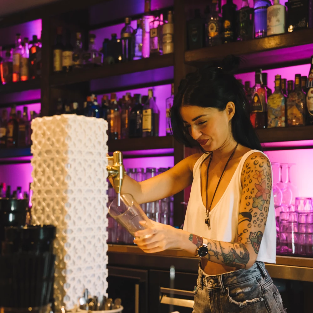 A female bar worker pulling a pint