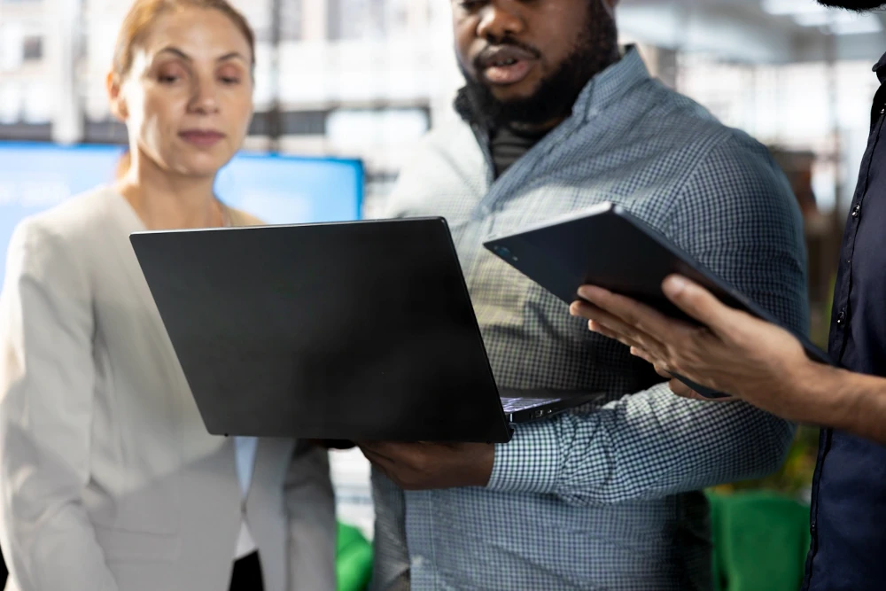 Company director showing shareholders data on a notebook.